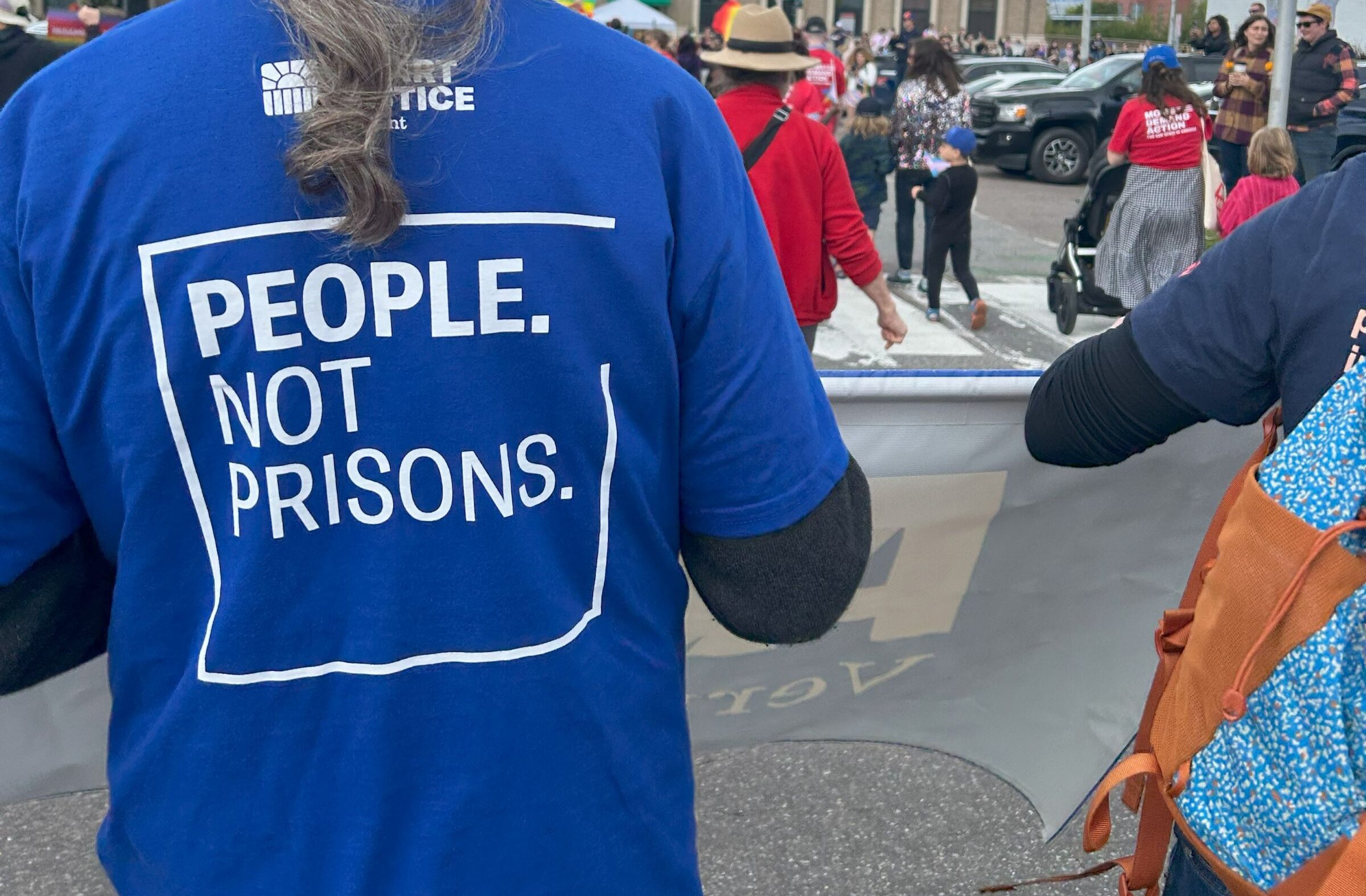 people not prisons written on shirt