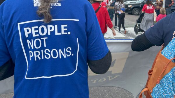 people not prisons written on shirt