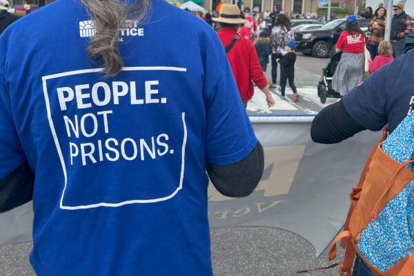 people not prisons written on shirt