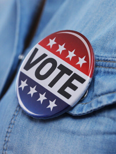 voting pin on denim shirt