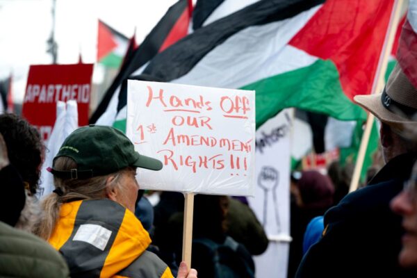 Protest sign reads "Hands Off our 1st Amendment Rights"