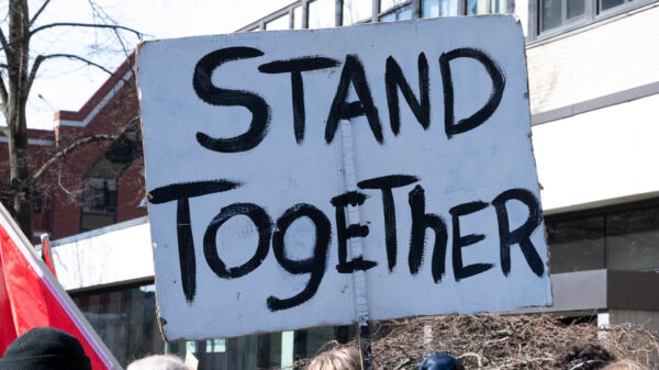 protest poster reads Stand Together