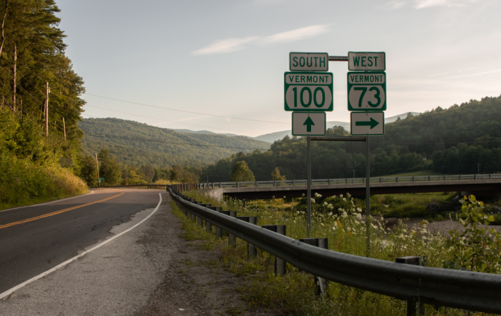 curving vermont state highway, sign reads route 100 south and 73 west