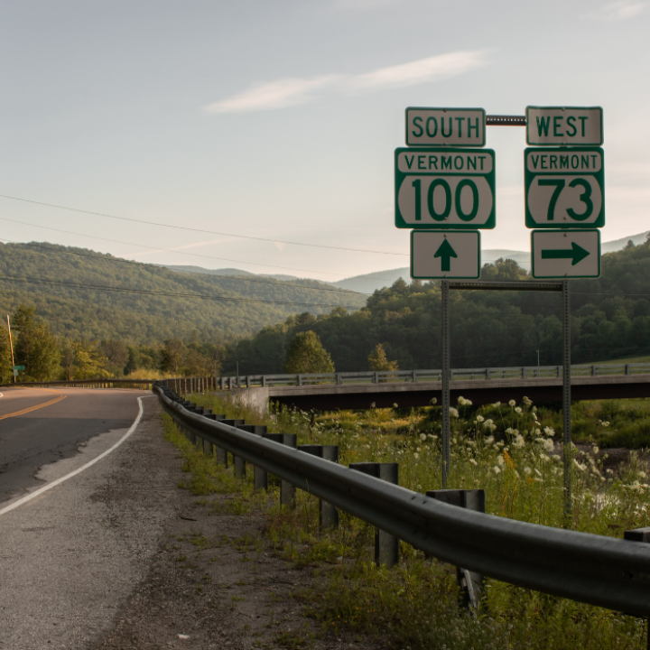 curving vermont state highway, sign reads route 100 south and 73 west